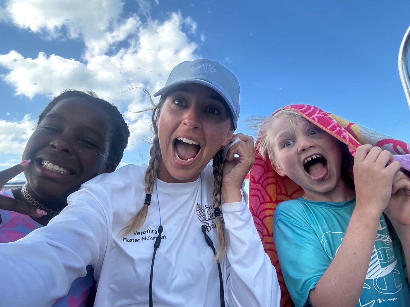 Captain Evan taking a selfie with kids on the shelling tour boat