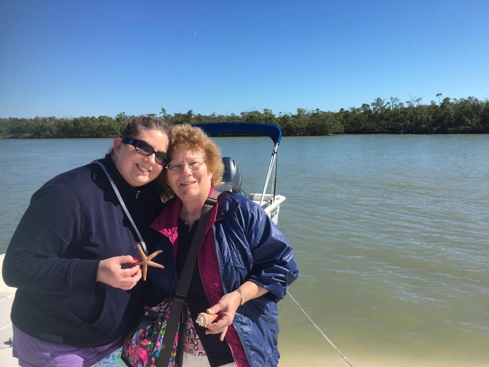 A mom and daughter hunting for seashells on a secluded Marco Island beach